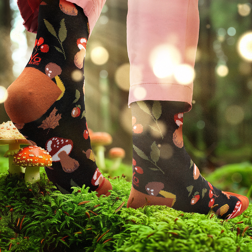 Mushroom themed socks walking in a mossy forest