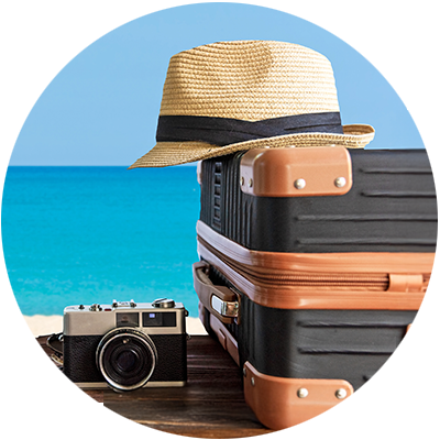 Photo of a beach with travel bags.